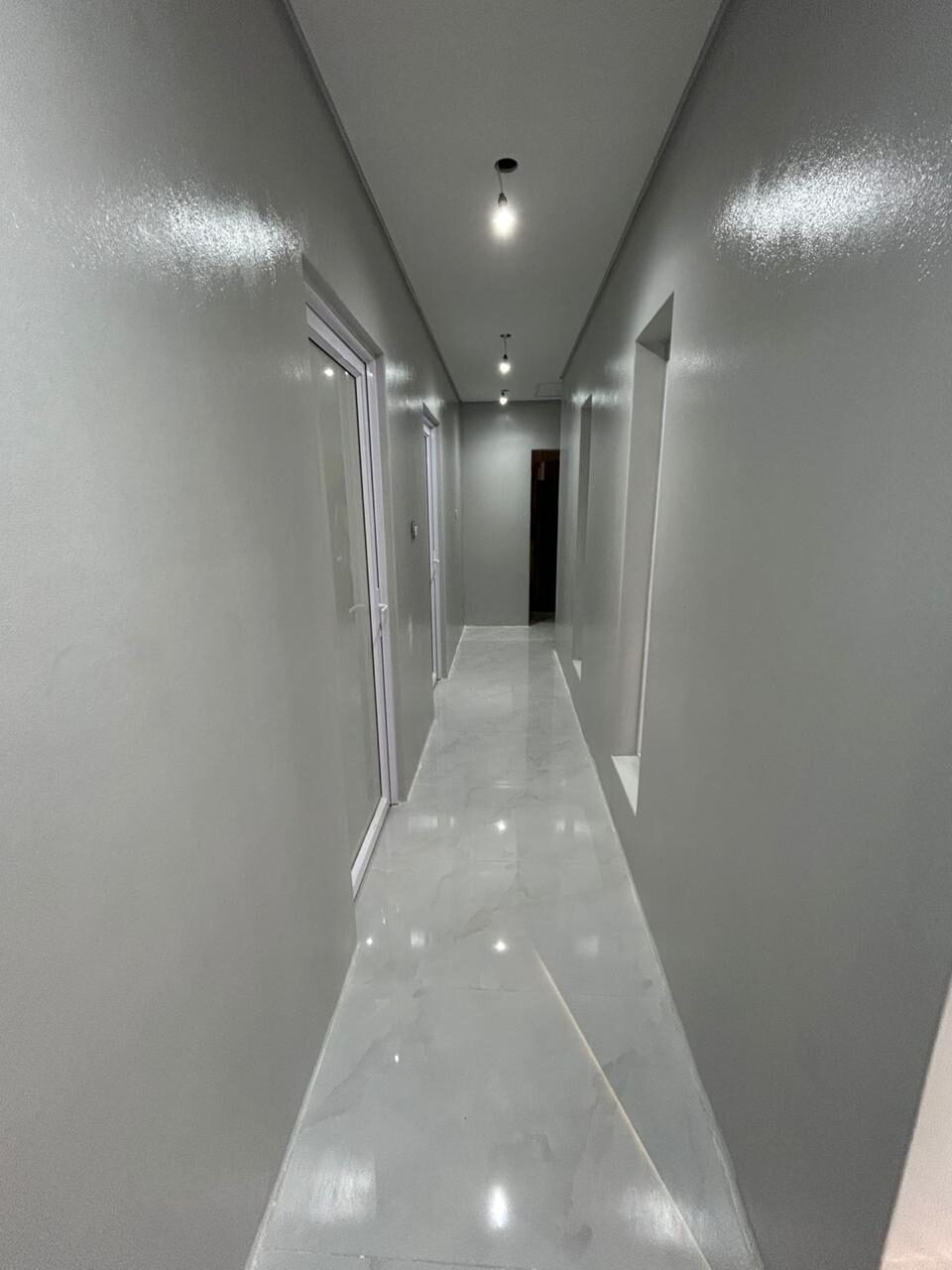The same hallway finished — painted, tiled and lit