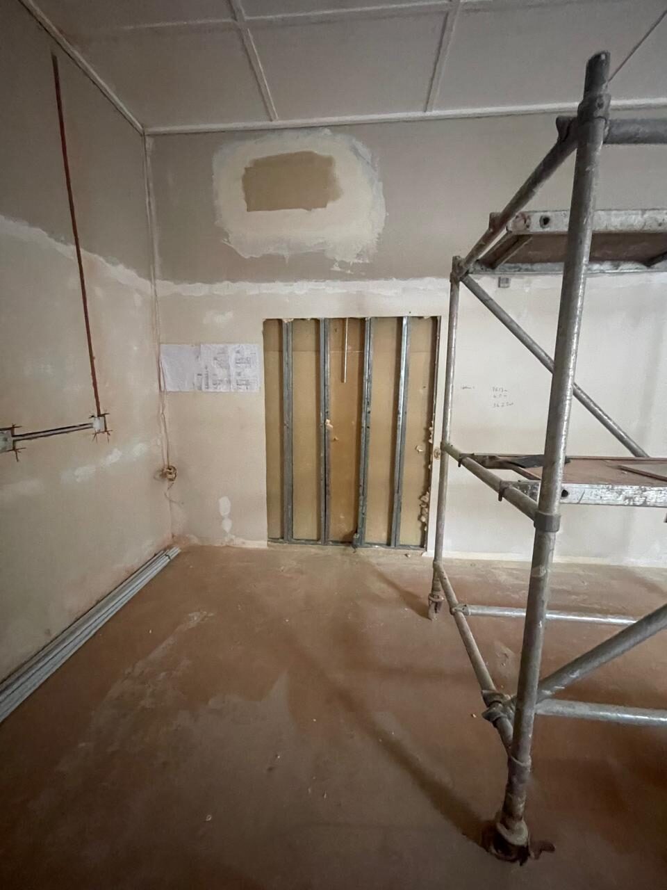 Stud-frame partition walls going up, scaffolding still in place