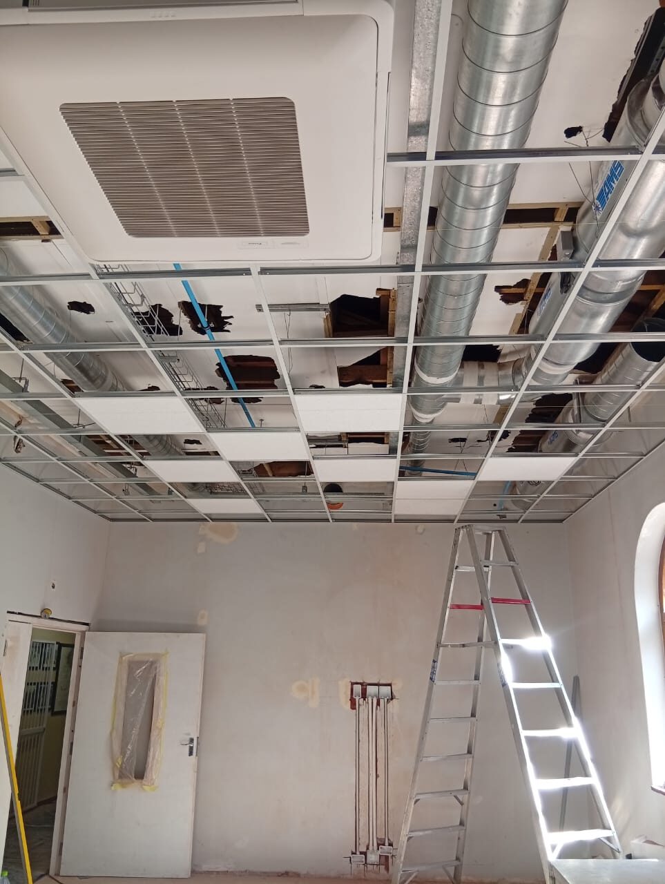Ceiling tiles, ducting and a new air-conditioning cassette going in