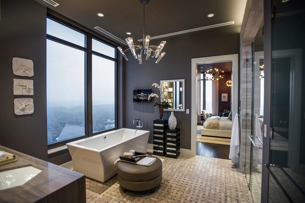 Indicative reference: a main ensuite with a freestanding bath set against full-height glazing